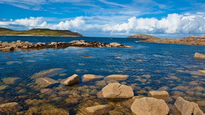 Rocky coast with blue sea and cloudy sky