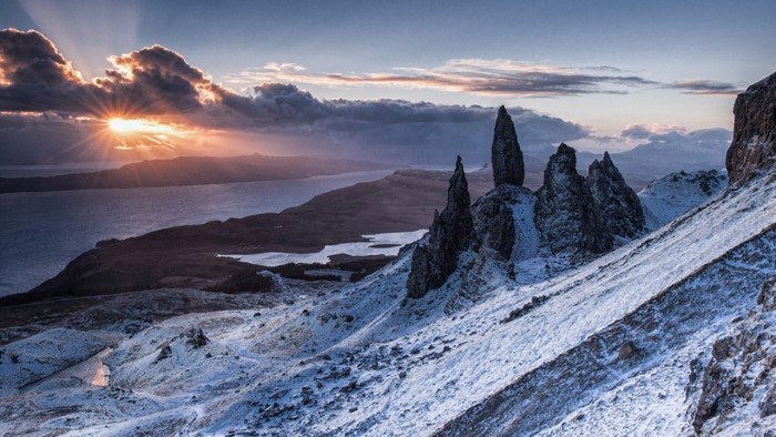 Sunrise over snowy mountains and a lake