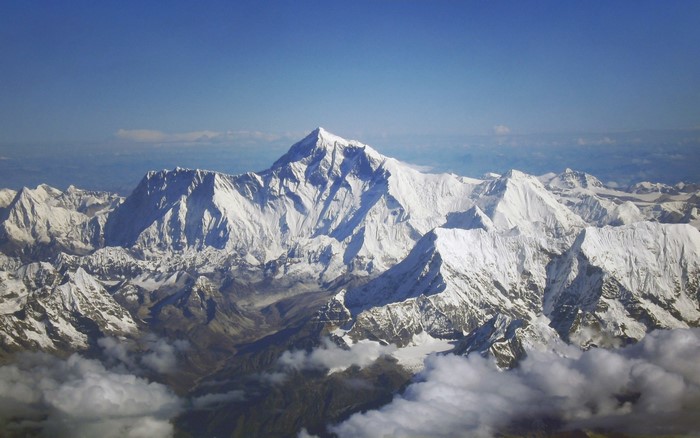 Snow-covered mountain range under a clear blue sky