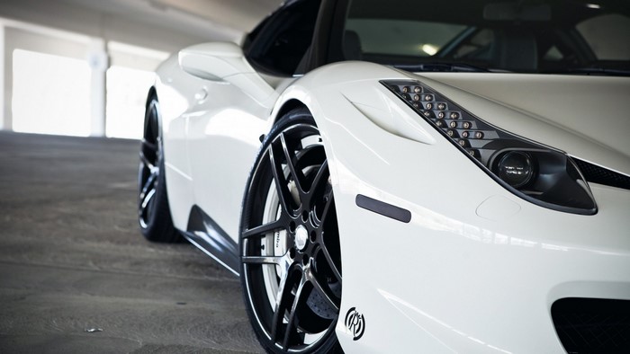 White Ferrari 458 Italia sports car with custom rims