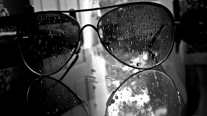 Monochrome sunglasses with water drops on glass