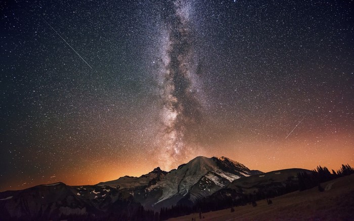 Milky Way over snow-capped mountains at night