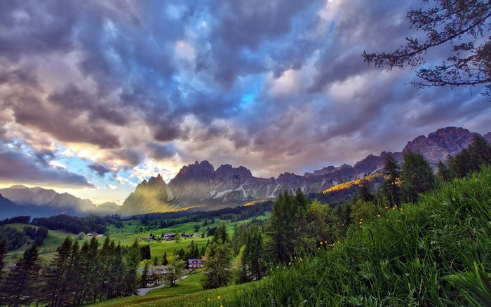 Mountain valley with dramatic clouds at sunset