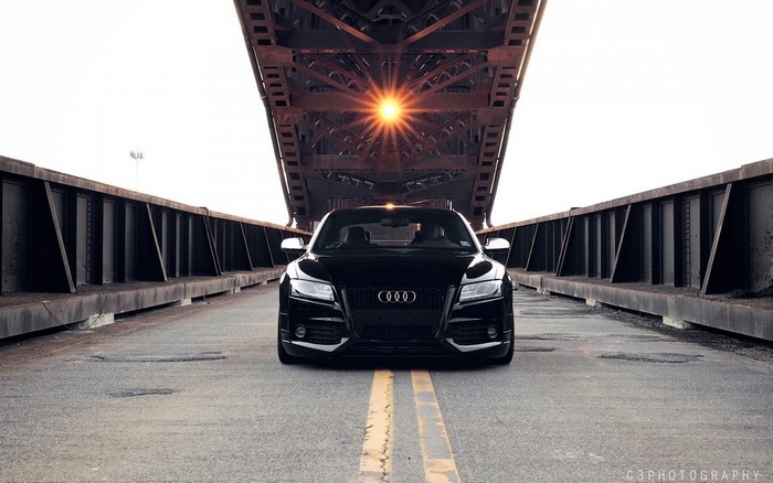Black Audi sports car on a bridge