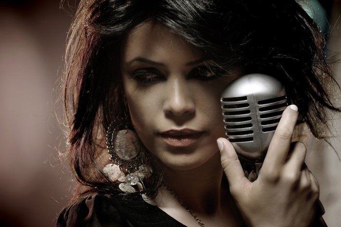 Woman holding a vintage microphone