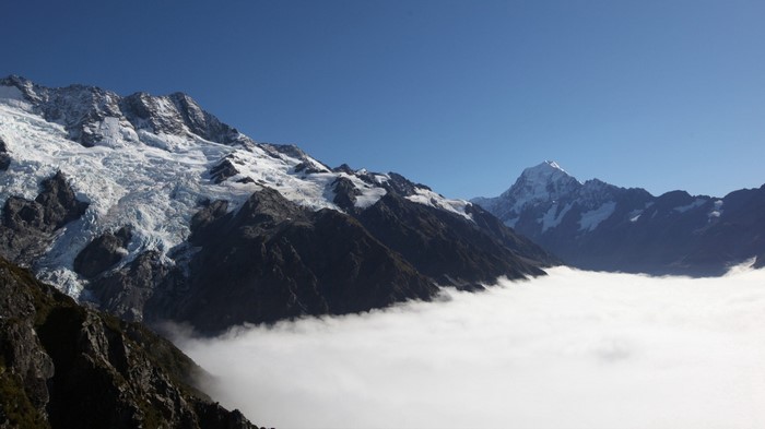 Snow-capped mountains with clouds below