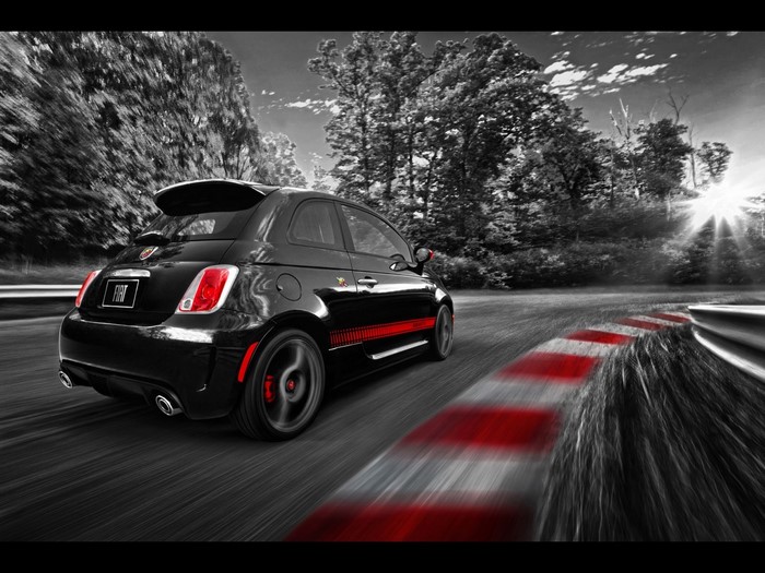 Black Fiat 500 Abarth driving on a race track