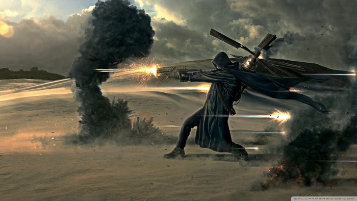 Man in black coat firing gun in desert with explosions