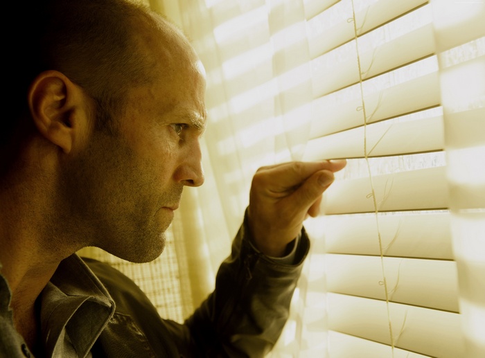 Jason Statham peeking through blinds