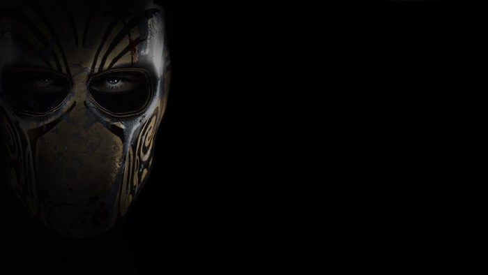 Masked figure in darkness