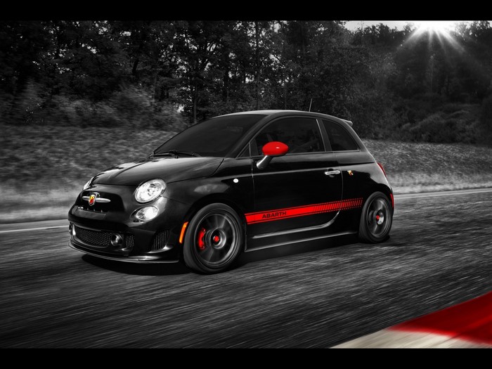 Black Fiat 500 Abarth with red accents on a road