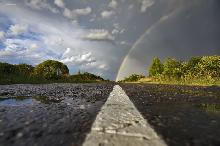 Road with rainbow after rain