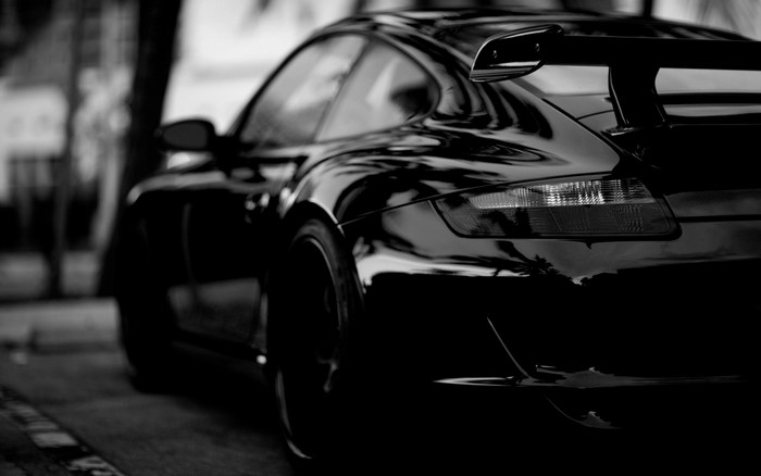 Black Porsche sports car with spoiler