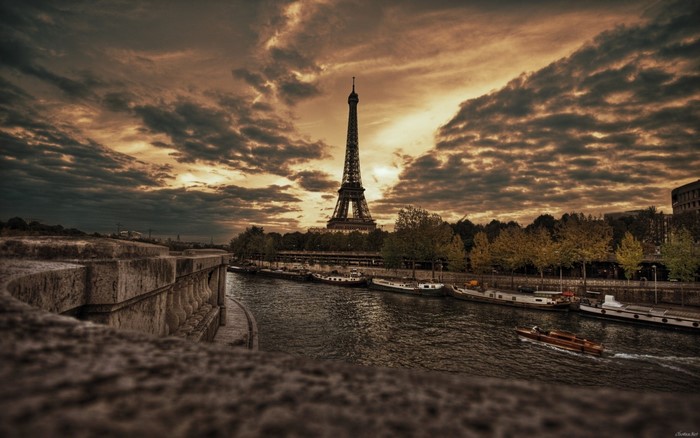 Eiffel Tower over Seine River at sunset
