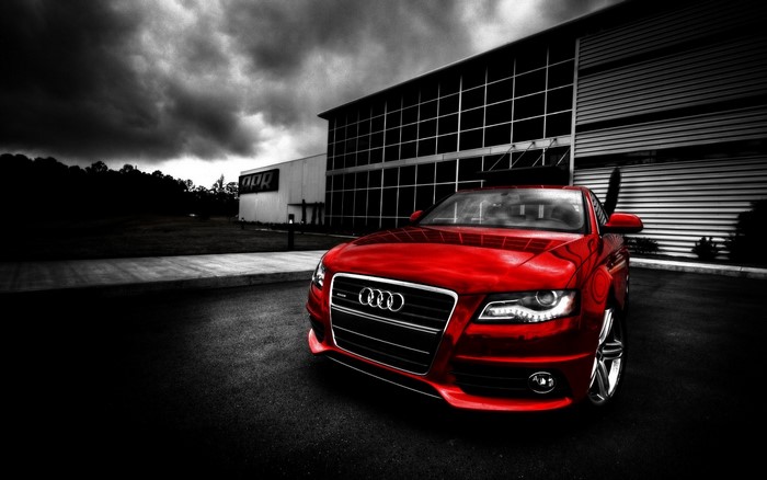 Red Audi S8 parked in front of APR building
