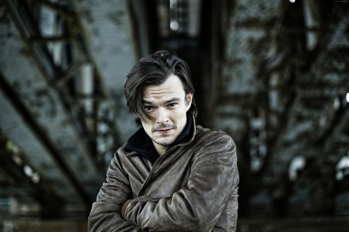 Dawid Ogrodnik wearing a leather jacket