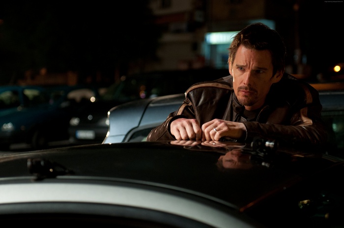 Ethan Hawke leaning on a car at night