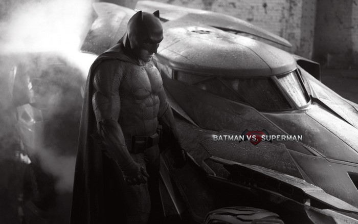 Batman from Batman v Superman standing by the Batmobile