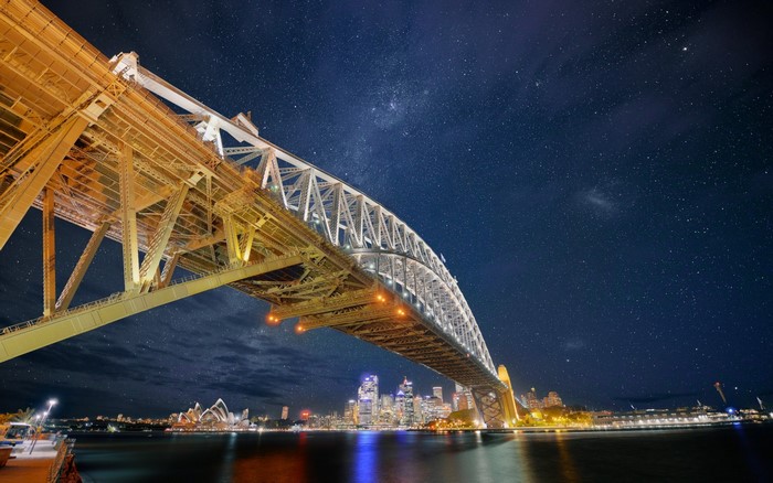 Sydney Harbour Bridge and Opera House at night with stars