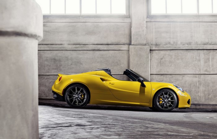 Yellow Alfa Romeo 4C Spider parked indoors