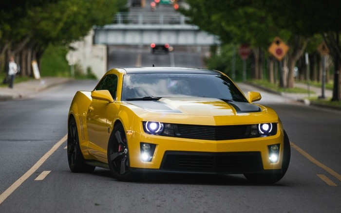 Yellow Chevrolet Camaro driving on a street