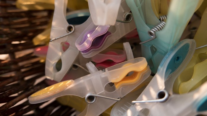 Close up of colorful clothespins in a basket