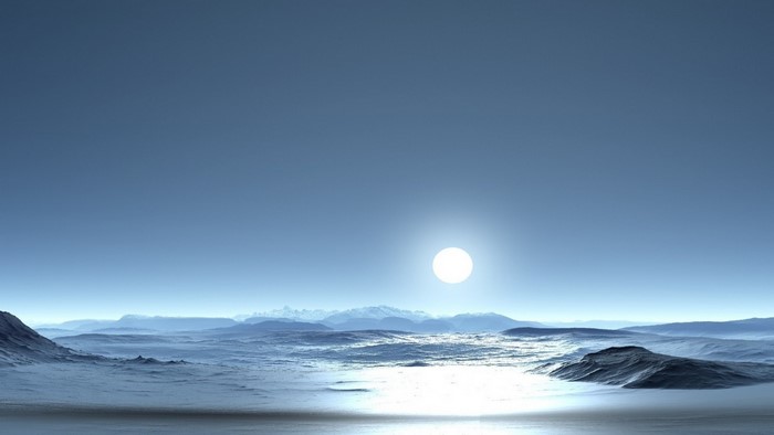 Sun over icy ocean with mountains