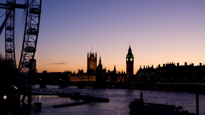 London skyline with the London Eye and Houses of Parliament at dusk
