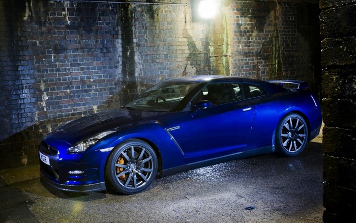 Blue Nissan GT-R parked in a brick tunnel