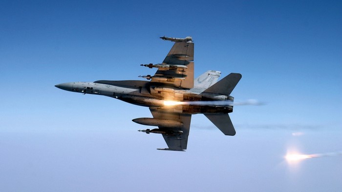 Fighter jet firing missile in the sky