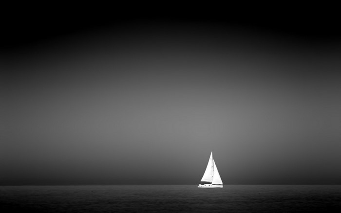Monochrome sailboat on the sea at night