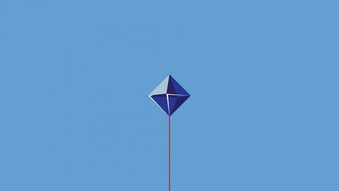 Blue geometric kite flying in a clear blue sky