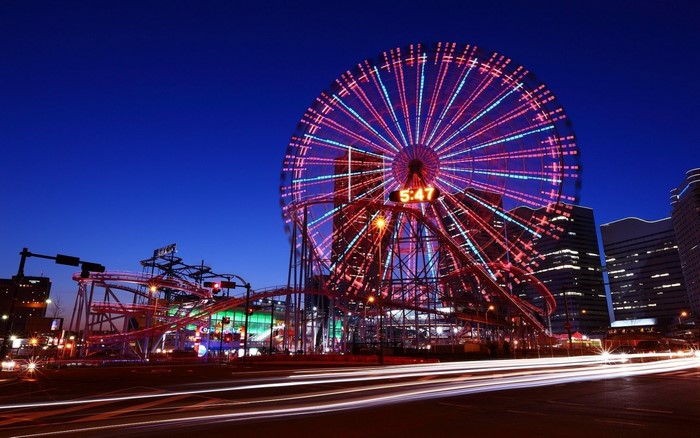 Ferris wheel and roller coaster at night in Japan