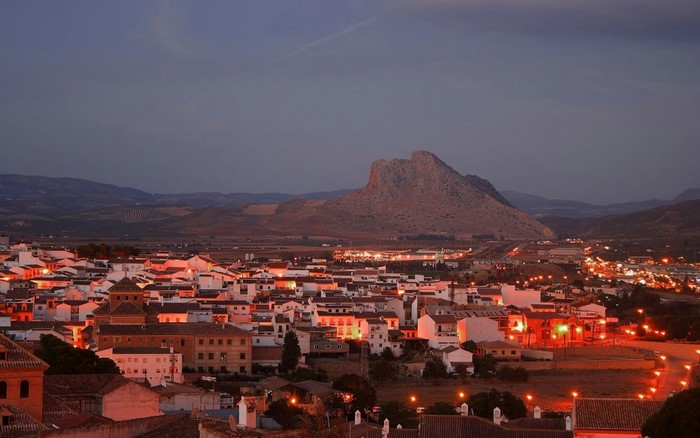 Town at dusk with mountain in background