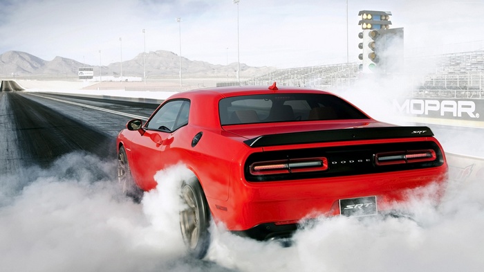 Red Dodge Challenger SRT Hellcat doing a burnout