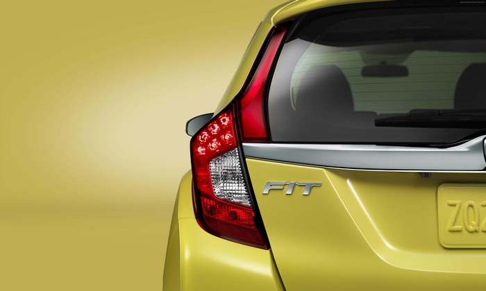 Yellow Honda Fit Hybrid rear view