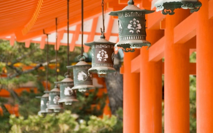 Japanese lanterns hanging under an orange roof