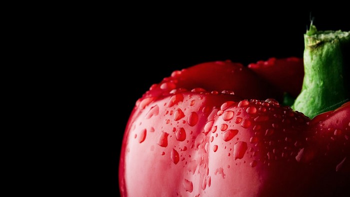 Close-up of a red bell pepper with water droplets
