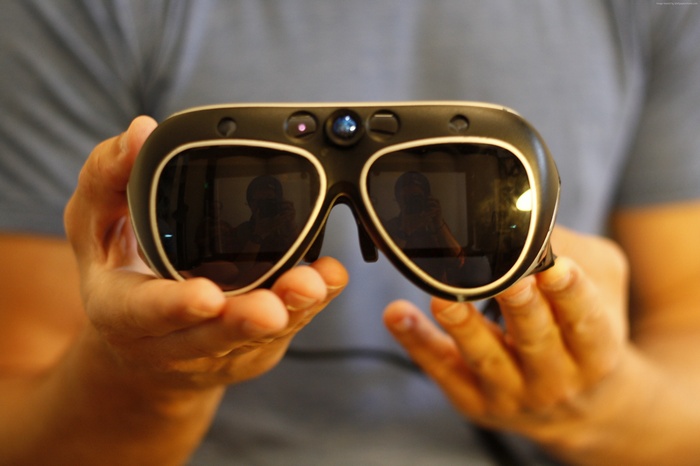 Hands holding a Meta 1 AR headset