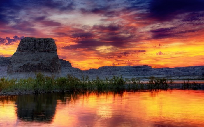 Dramatic sunset over a lake with rock formations