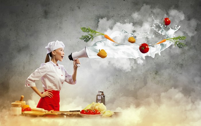 Chef with megaphone and flying vegetables