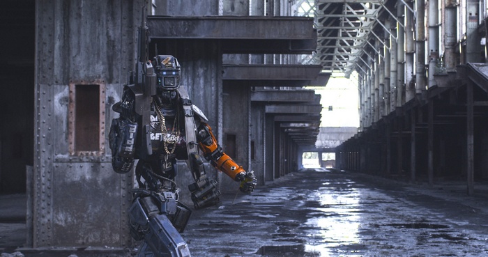Chappie robot with gun in abandoned factory
