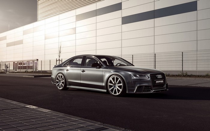 MTM tuned Audi S8 sedan parked in front of a modern building