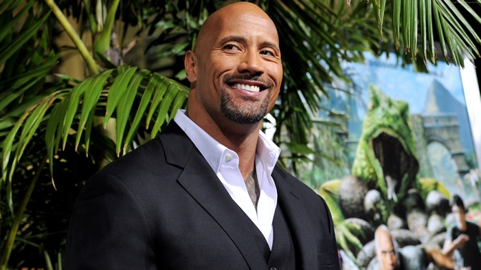 Dwayne Johnson in a suit with a jungle backdrop