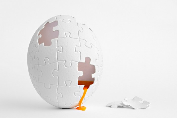 Puzzle egg with orange yolk spilling out