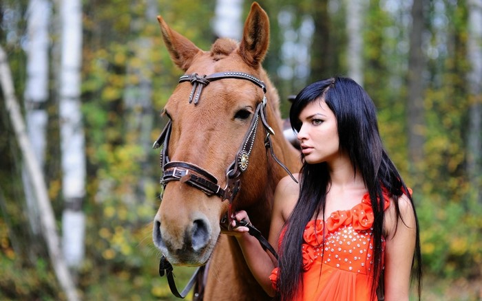 Woman with long dark hair and a brown horse