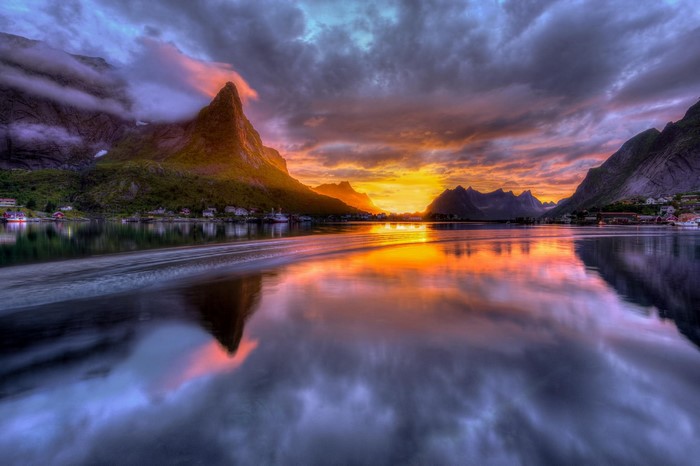 Sunset over a Norwegian fjord with mountains and a town