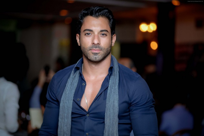 Male model wearing a blue shirt and scarf