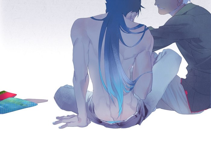 Two men sitting, one shirtless with blue hair