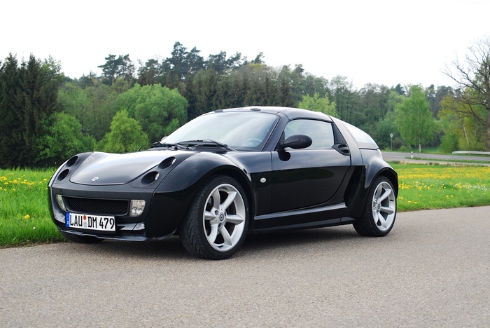 Black Smart Roadster Brabus sports car on a road